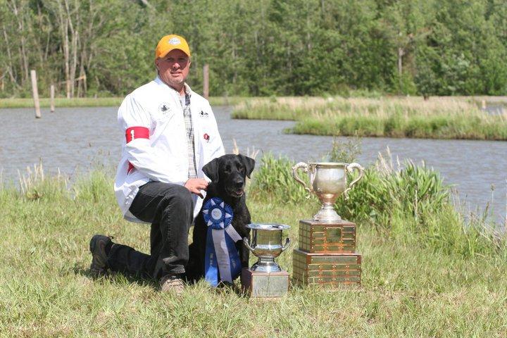 man and dog and trophies